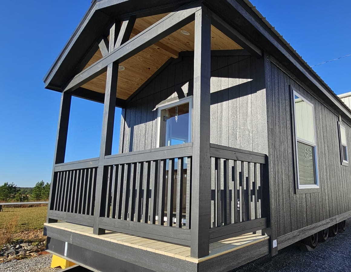 Wood spindle porch railing option on a charcoal Phoenix park model home