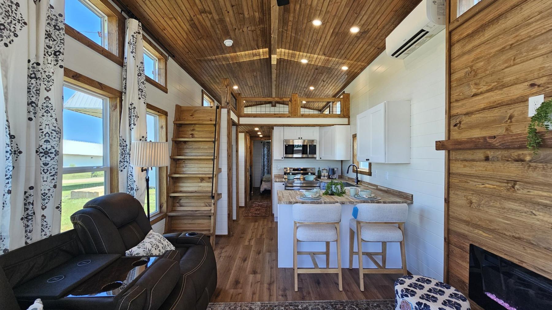 Furnished Phoenix park model living room and kitchen with wood vaulted ceiling, loft and breakfast bar